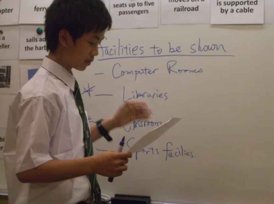 Student presenting ideas at the whiteboard